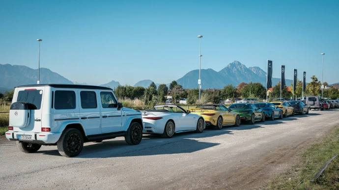 Several luxury cars parked in a line outdoors.